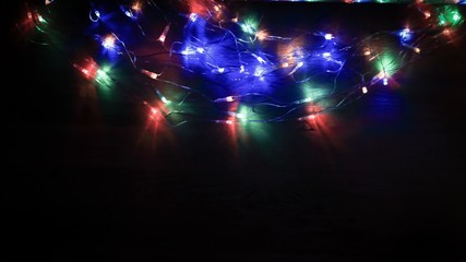 Christmas tree garland laid out on a wooden table