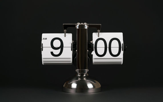 Isolated vintage flip clock on black background at nine o'clock - Powered by Adobe