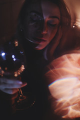 Attractive woman holding glass. Light effects blue and pink color