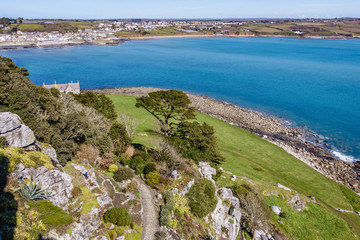 Fototapeta premium view from top to bottom garden with trees and sea-rocky coastline and bluish-green water