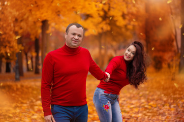 Fototapeta premium Romantic walk of young couple in park in autumn