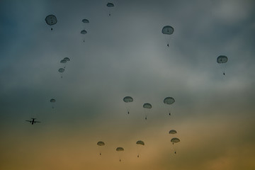 Army paratroopers jumping at air war action.