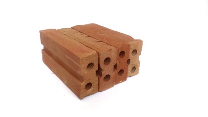 Small red bricks for construction with white background.