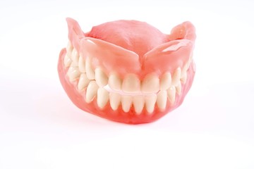 Artificial dentures of the two halves on a white background