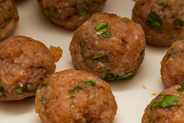 Close up of homemade turkey, bacon, onion and basil meat balls