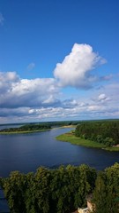 Fototapeta na wymiar Blue sky and blue lake in summer. White clouds are reflected in the water. The famous lake Seliger. Russia.
