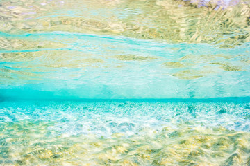 Fototapeta na wymiar Light blue and gold coloured underwater abstract of shallow Mediterranean sea