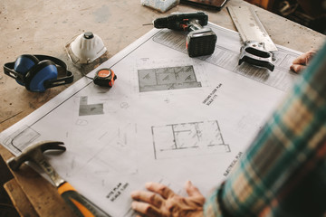 Floor plan on table with carpentry tools