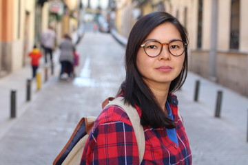 Determined Asian woman outdoors close up 