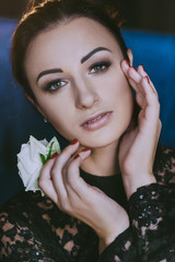 woman with a smooth hairdo holds a rose
