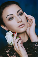 woman with a smooth hairdo holds a rose