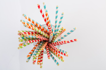 Top view of striped paper straws in a glass