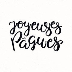 Hand written calligraphic lettering quote Joyeuses Paques, Happy Easter in French, on a distressed background. Hand drawn vector illustration. Design concept, element for card, banner, invitation.