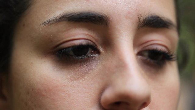 Woman opening eyes. Extreme close-up of female awakening from meditation break