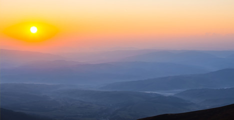 beautiful mountain valley in a mist at the sunrise, early morning mountain landscape