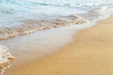 Natural background by sea wave on sand. Vacation and holiday concept.