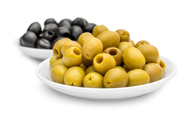 Saucers with black and green olives on white.
