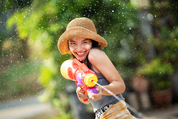Asian woman are using water guns play in the Songkran festival