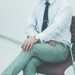 concept of business success - businessman sitting on a chair in 