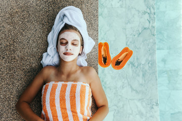 Teen girl applying organic fruit facial mask