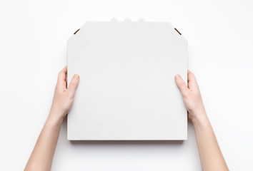 Courier holding pizza box in hands isolated on white