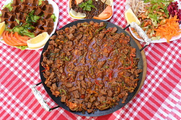 diced lamb fried on iron plate 