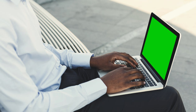 Millennial Man Typing On Laptop With Green Screen