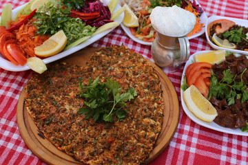 very thin turkish pizza covered with seasoned minced meat and onions 