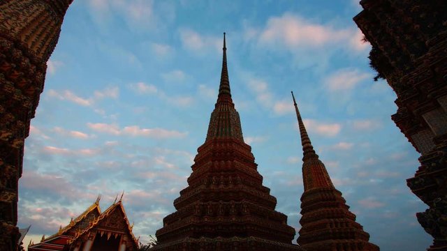 Wat Pho timelapse with cloud moving evening become night and gold light at pagoda 