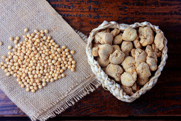 Soybean meat, chunks in a basket with heart shape. Raw soybeans chunks on rustic wooden background