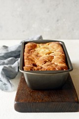 Pancake pie with meat and mushrooms on a gray background. Pancake cake in the form of bread. Slavic cuisine. Pancake pie with meat and mushrooms on a gray background, copy space. Shrovetide Maslenitsa