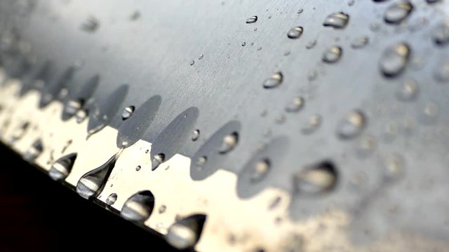 Chef's knife close-up. Knife santoku. blade blade. Drops of water flow down the blade of a knife. Cut vegetables. Cook lunch. Reflection of cold weapons.