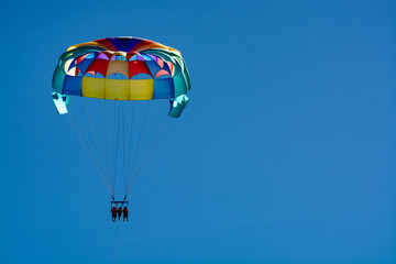 Sea and beach sport for tourists, parasailing in blue sky