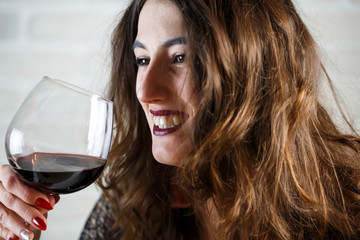 Young beautiful woman laughs while talking on a blind date. Closeup portrait.