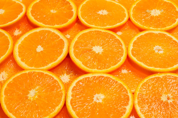 Slices of oranges as a background, top view.