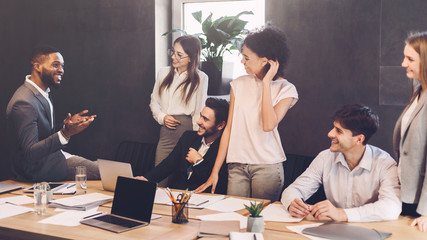 Business team having break and talking at meeting