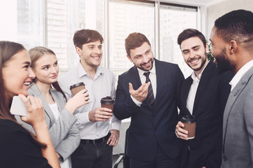 Successful business people talking, having coffee break