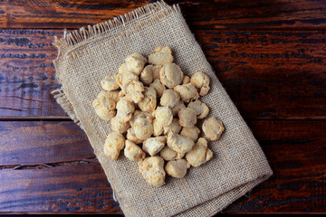 Soybeans meat, chunks on rustic fabric towel. Raw soybeans chunks on rustic wooden background