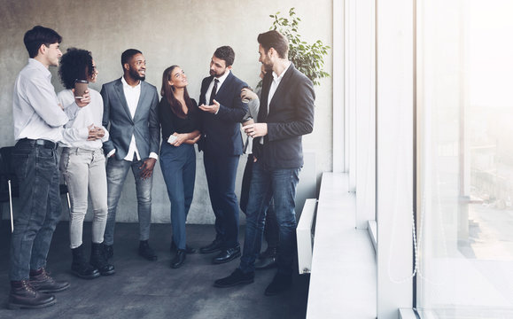 Business team talking at coffee break near window