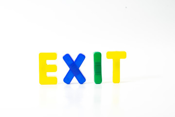 Colorful plastic letters create the word exit against a white background.