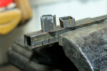 metal clutches in them clamped square tube. there is still a piece on top. shallow depth of cut.