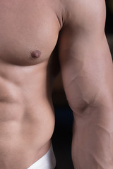 a man is engaged in bodybuilding in the gym, raises the bar and trains his muscles.