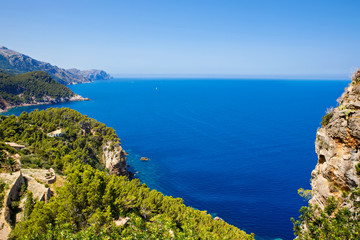 Fototapeta na wymiar Island scenery, seascape of Mallorca Spain. Idyllic coastline of Majorca, Mediterranean Sea on sunny day. Turquoise water and green hills of Serra de Tramuntana.