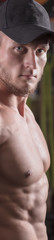 Naklejka premium a man is engaged in bodybuilding in the gym, raises the bar and trains his muscles.