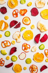 Dried vegetables and fruits on a white background, top view.