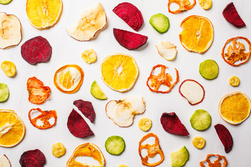 Dried vegetables and fruits on a white background, top view.
