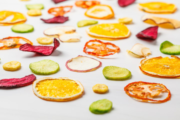 Dried vegetables and fruits on a white background.
