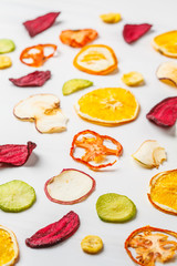 Dried vegetables and fruits on a white background.