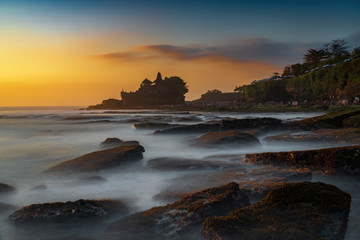 Naklejka na ściany i meble Sunset view of tanah lot temple on Sea in Bali Island. one of most famous tourist attraction in Indonesia.