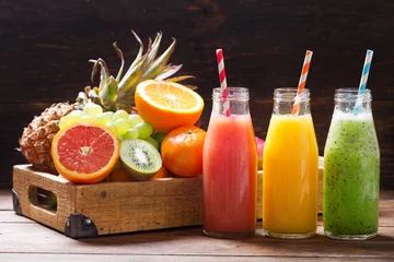  bottles of fruit juice and smoothie with fresh fruits © Nitr